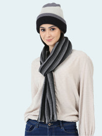 Woman wearing a striped beanie and scarf on a white background