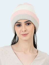 Woman wearing a pink and gray striped beanie on a white background