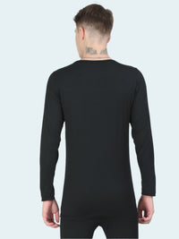 Person wearing a black long-sleeve base layer top on a white background