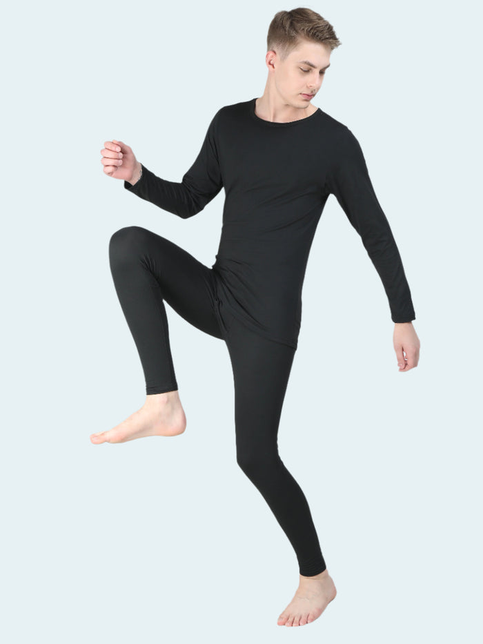Man wearing a black thermal base layer on a white background