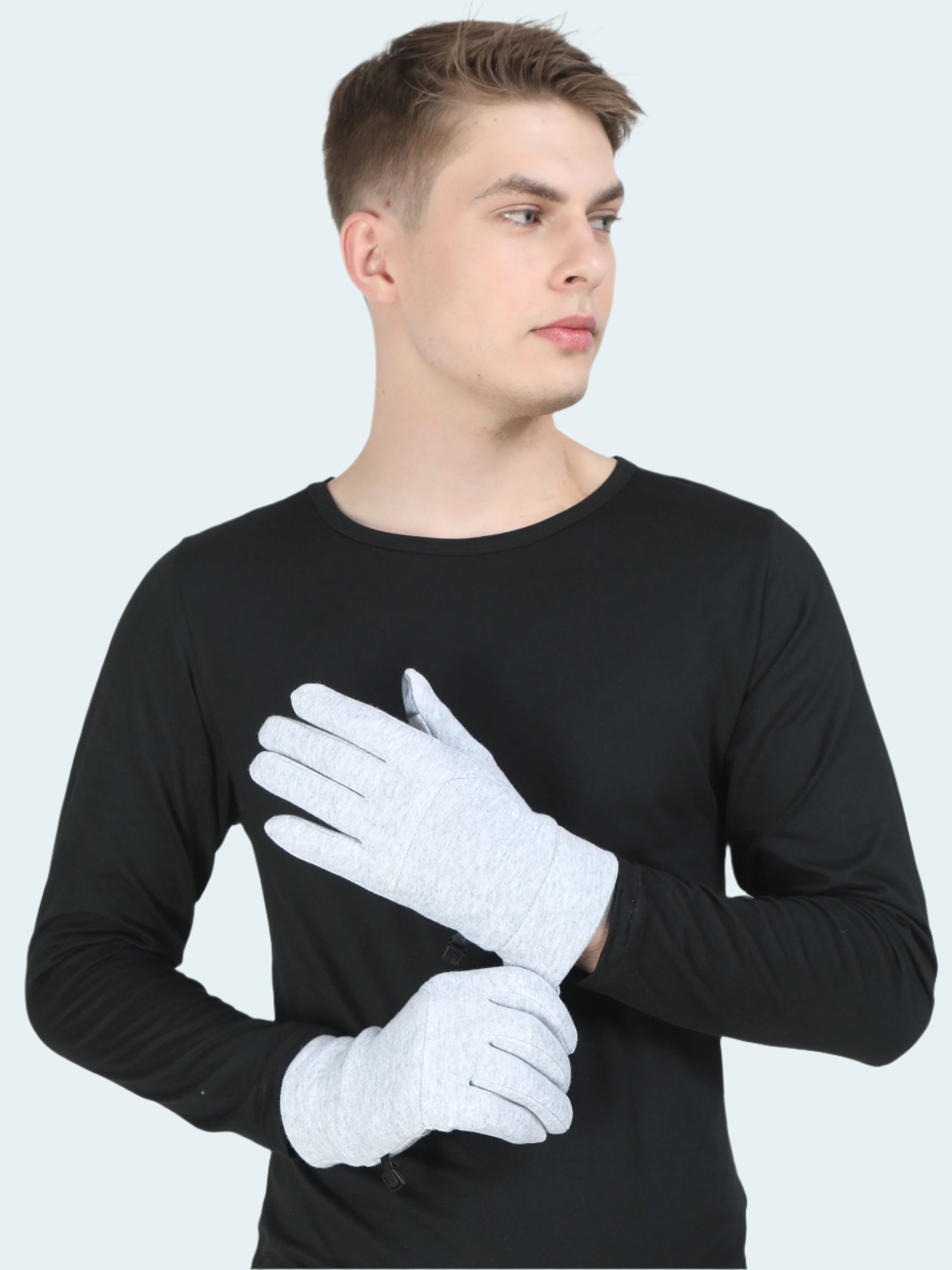 Man wearing a black long-sleeve shirt and white gloves on a light gray background