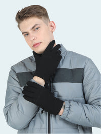 Person wearing black gloves and a gray jacket on a white background