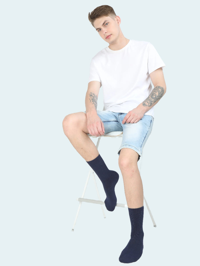 A pair of black thermal socks worn on legs against a white background