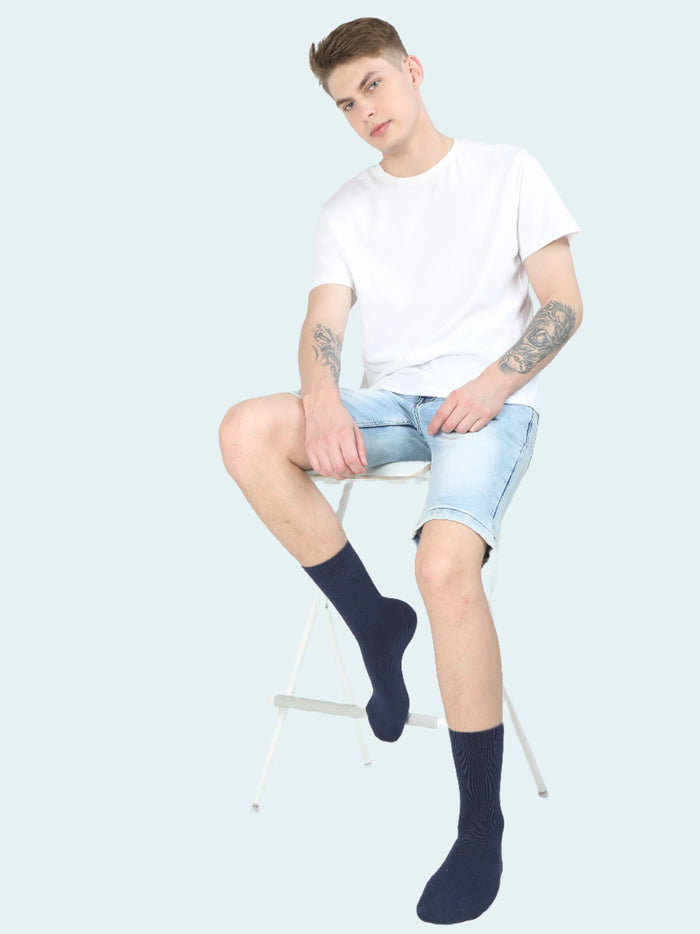 A pair of black thermal socks worn on legs against a white background