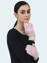 Woman wearing pink gloves against a light gray background