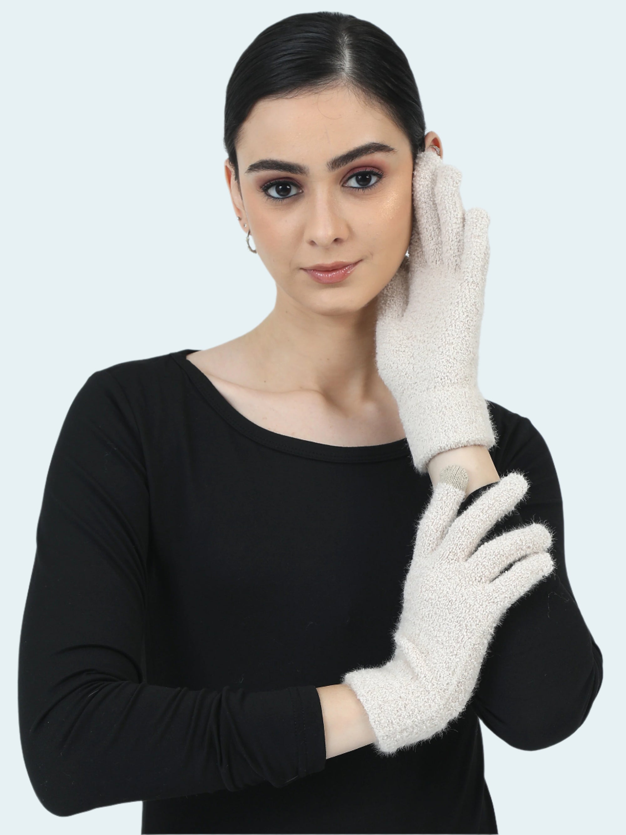 Woman wearing white gloves against a plain background