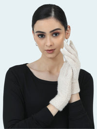 Woman wearing a black top and white gloves against a light gray background
