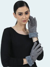 Woman wearing gray gloves against a light gray background