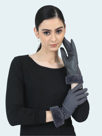 Woman wearing gray gloves with a plain background