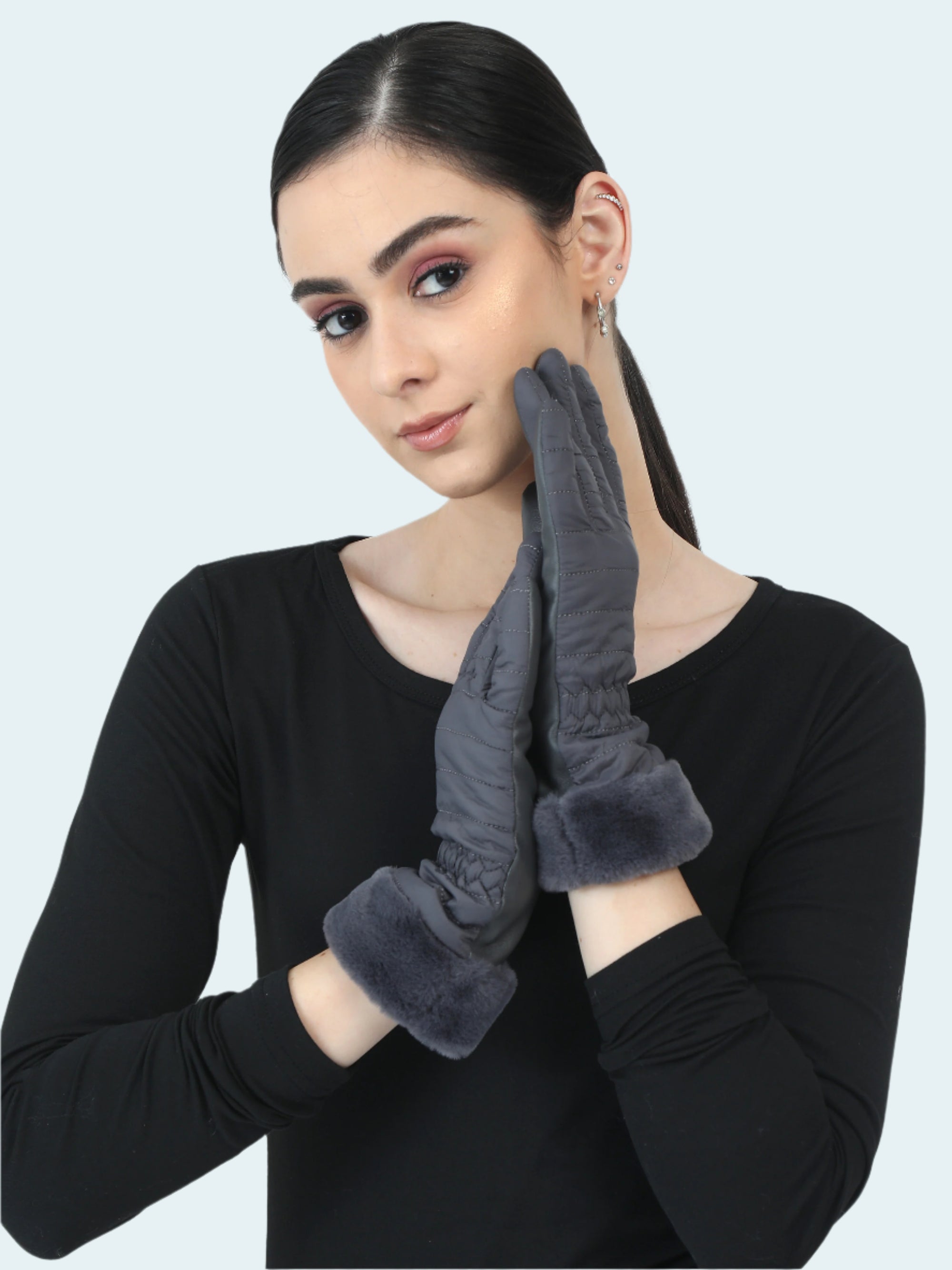 Woman wearing gray gloves on a white background