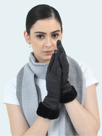 Woman wearing black gloves and a gray scarf on a white background