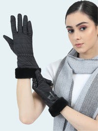 Woman wearing black gloves with fur cuffs on a white background