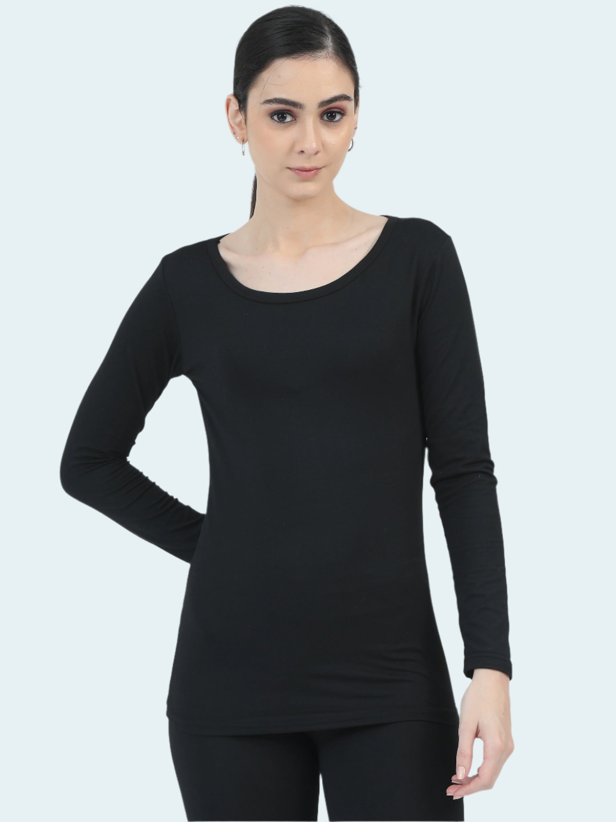 Woman wearing a black long-sleeve top against a white background