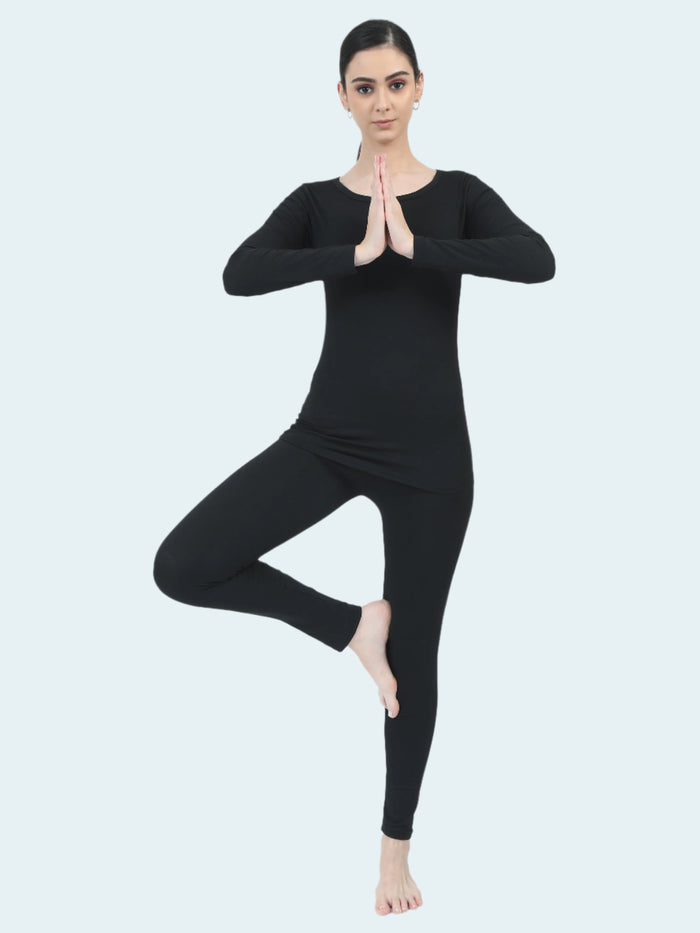 Person wearing a black full-body suit on a white background