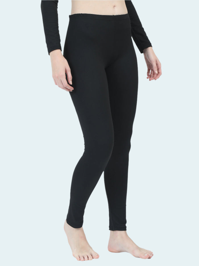 Person wearing black thermal base layer on a white background