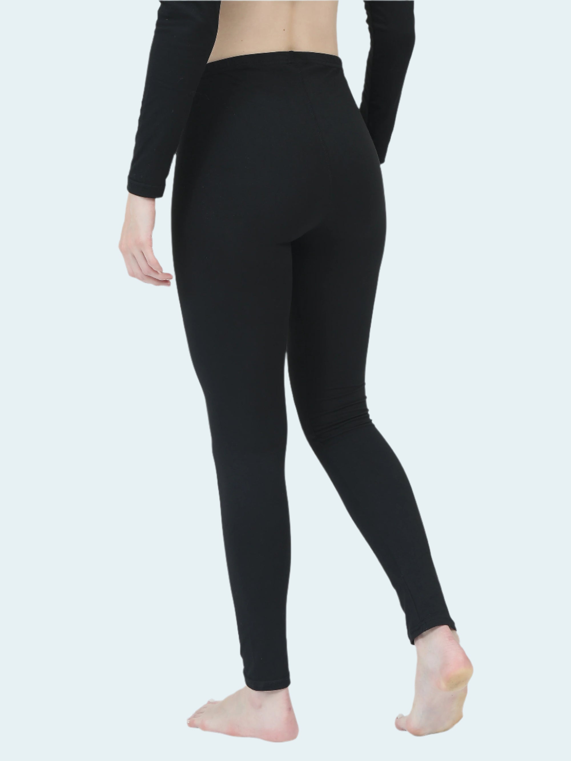 Person wearing black thermal base layer on a white background