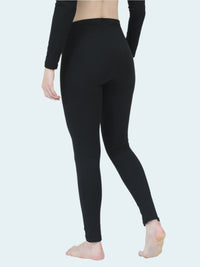 Person wearing black thermal base layer on a white background