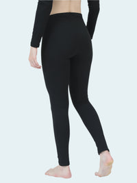 Person wearing black thermal base layer on a white background