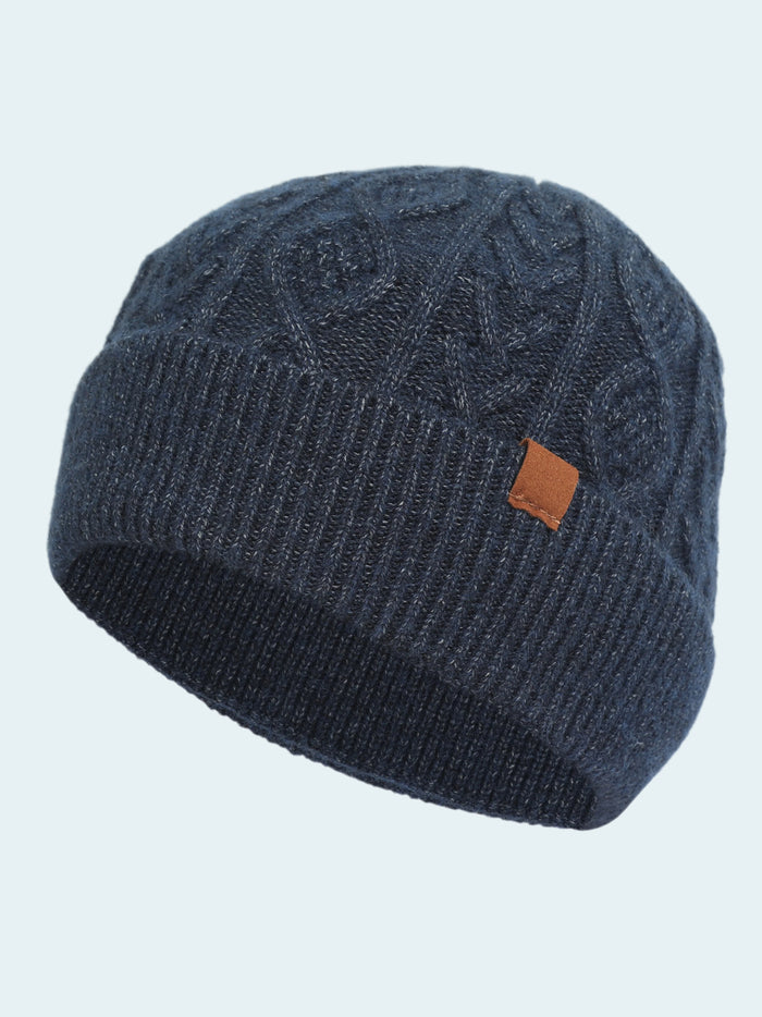 Blue knit beanie with a brown logo patch on a white background