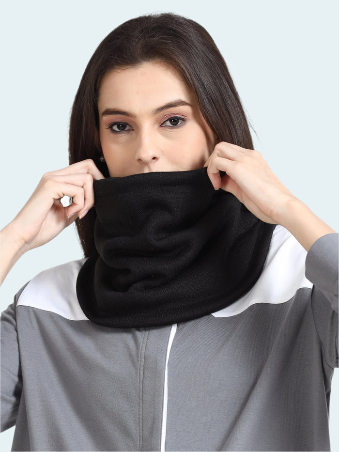 Person wearing a black neck gaiter against a white background