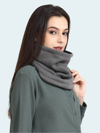 Woman wearing a gray cowl neck sweater against a white background