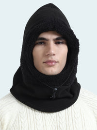 Person wearing a black balaclava against a white background