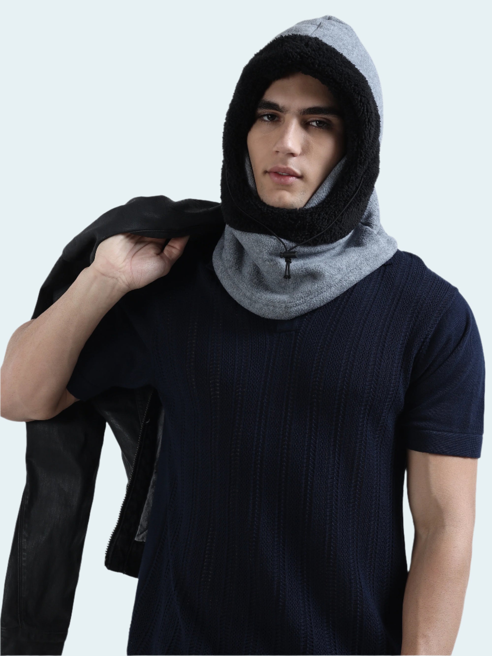 Person wearing a black and gray hooded balaclava against a white background