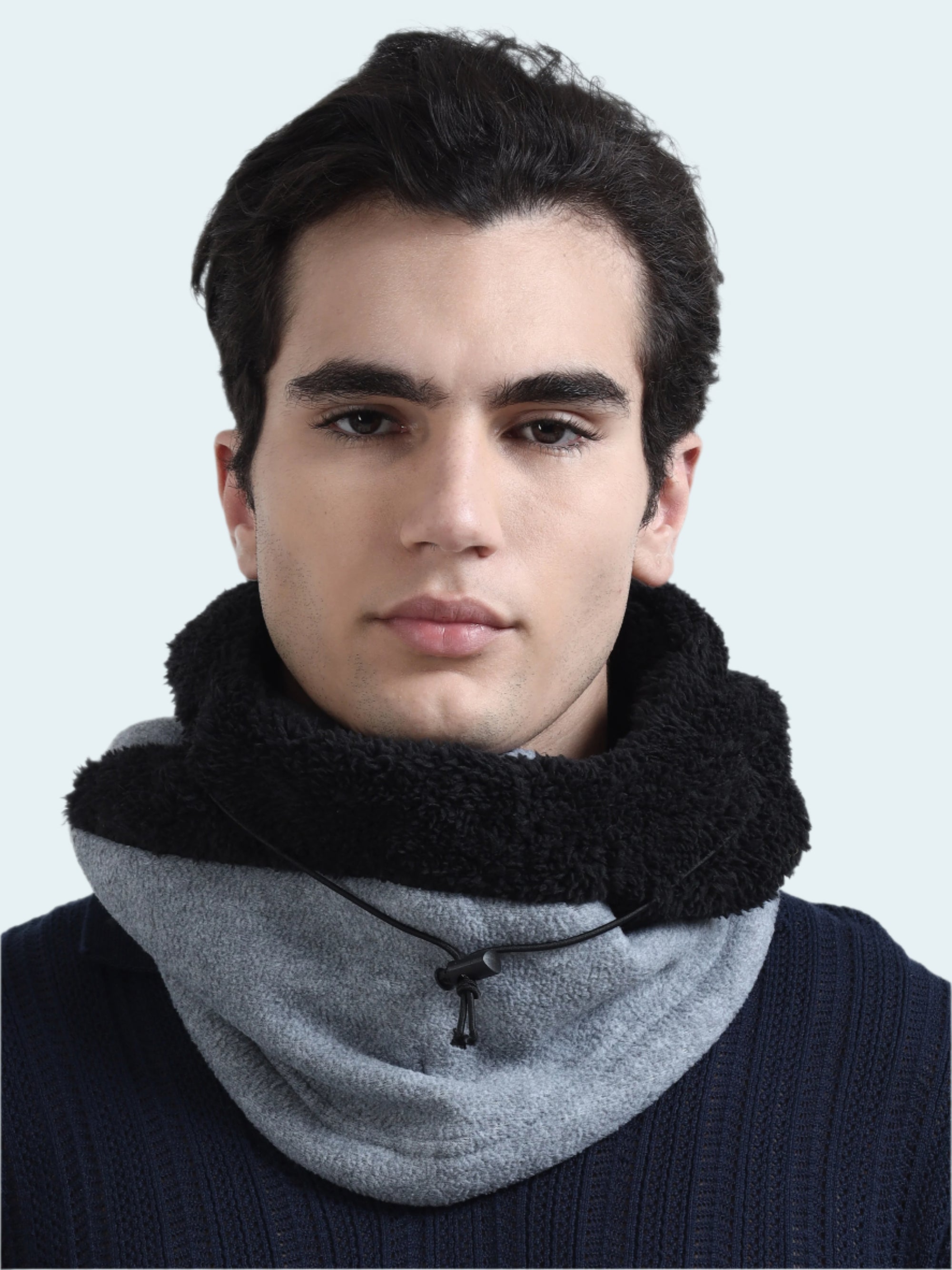 Man wearing a gray balaclava with a black sherpa lining on a white background