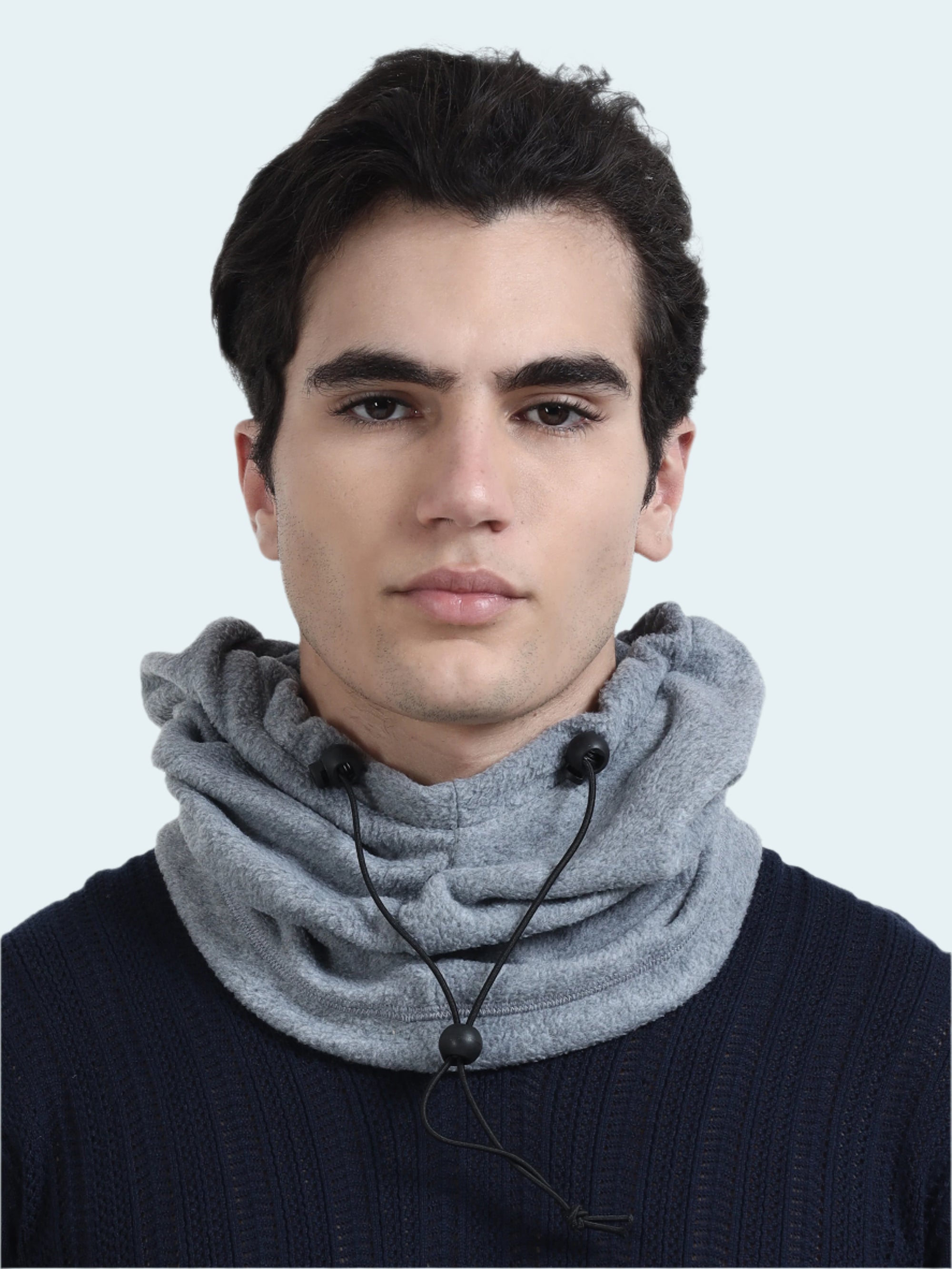 Man wearing a gray balaclava with black beads on a white background