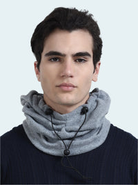 Man wearing a gray balaclava with black beads on a white background
