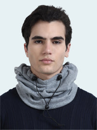 Man wearing a gray balaclava with black beads on a white background