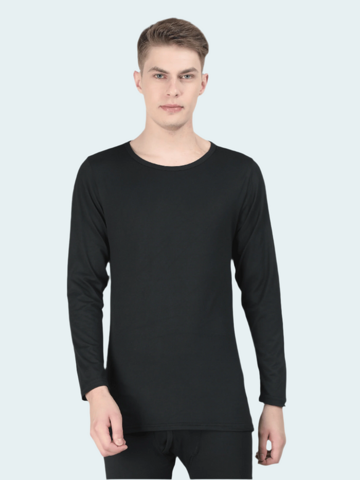 Man wearing a black long-sleeve shirt against a gray background