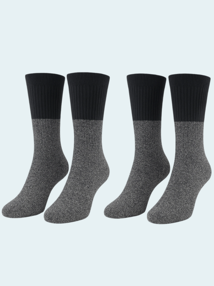 Four pairs of black and gray socks on a light gray background