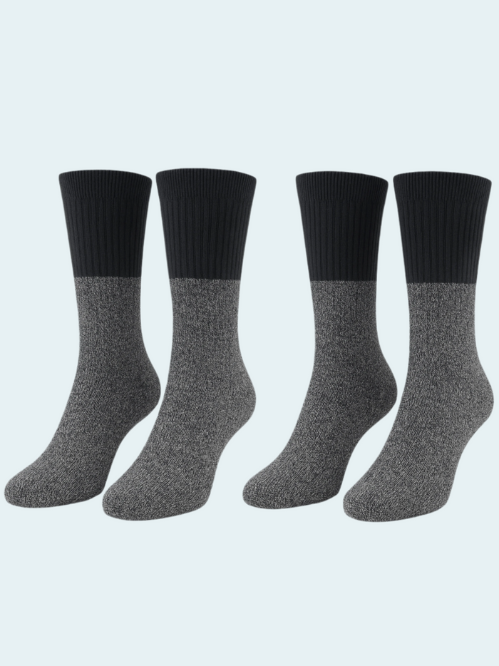 Four pairs of black and gray socks on a light gray background