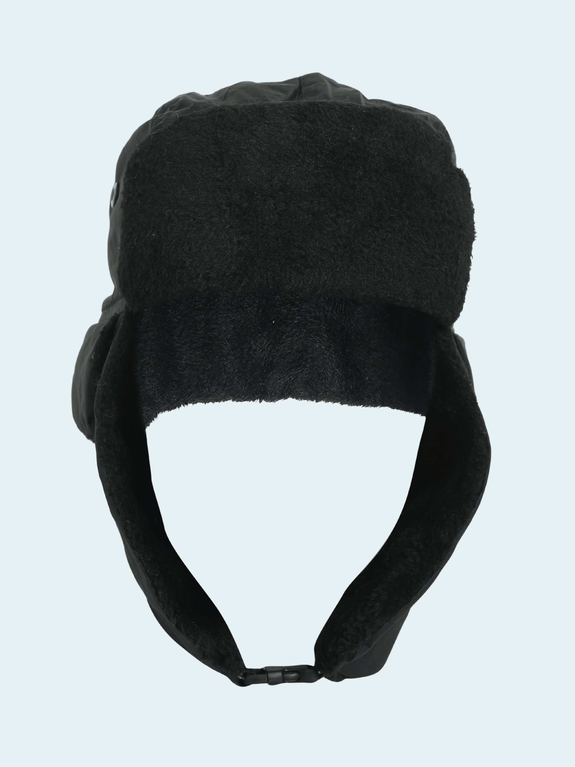 Black winter hat with ear flaps on a light gray background