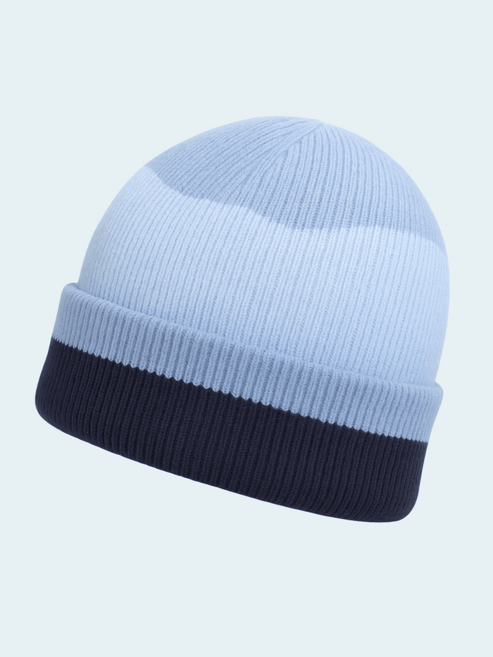 Two-tone blue beanie with light blue top and dark blue bottom on a light blue background