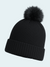 Black knit beanie with a fluffy pom-pom on a light gray background
