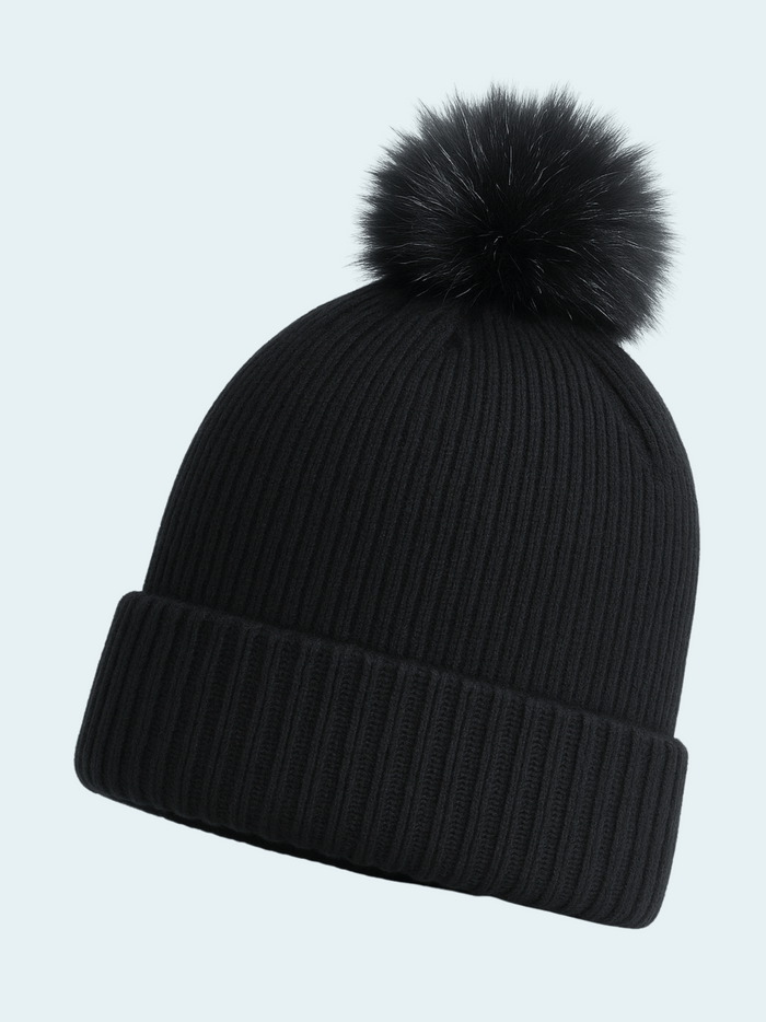Black knit beanie with a fluffy pom-pom on a light gray background
