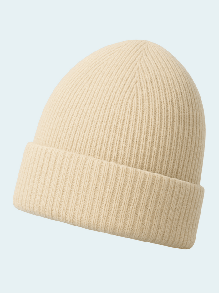 Beige knit beanie on a light blue background