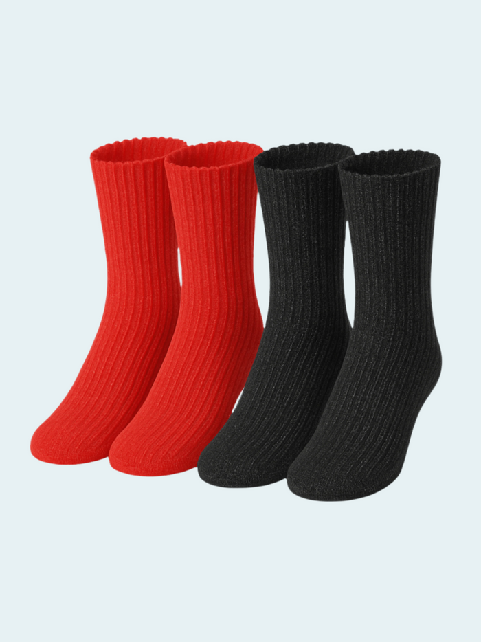 Two pairs of red and black chenille socks on a light gray background