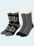 Two pairs of socks with snowflake patterns on a light gray background