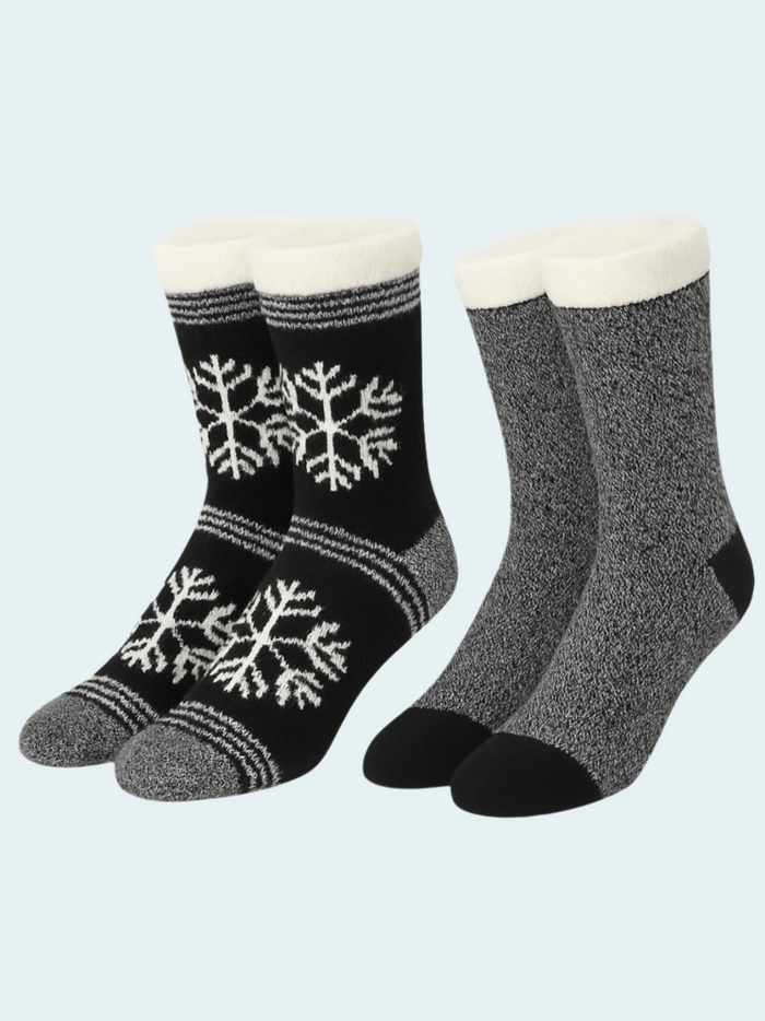 Two pairs of socks with snowflake patterns on a light gray background