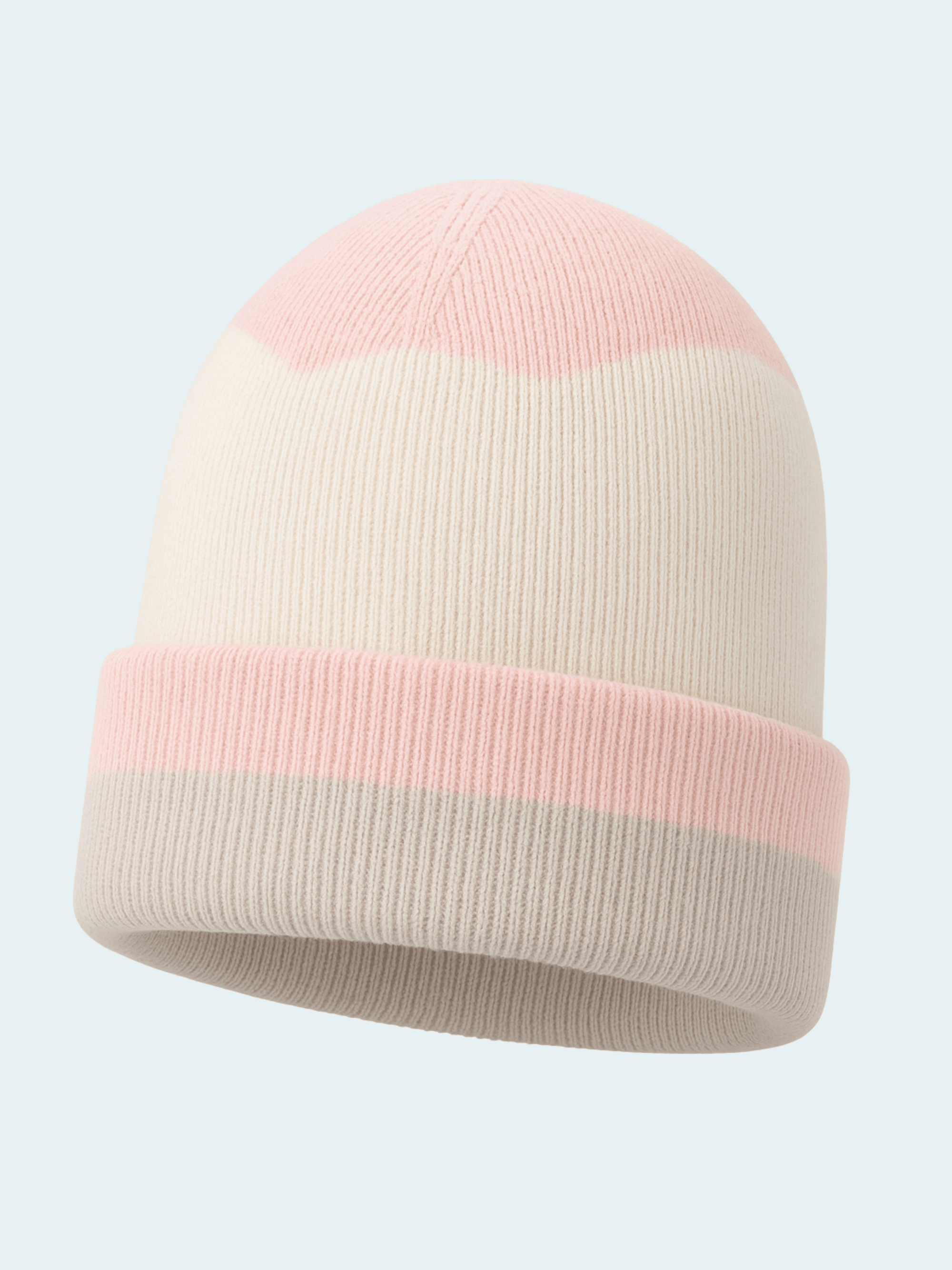 Two-tone pink and beige beanie on a light gray background