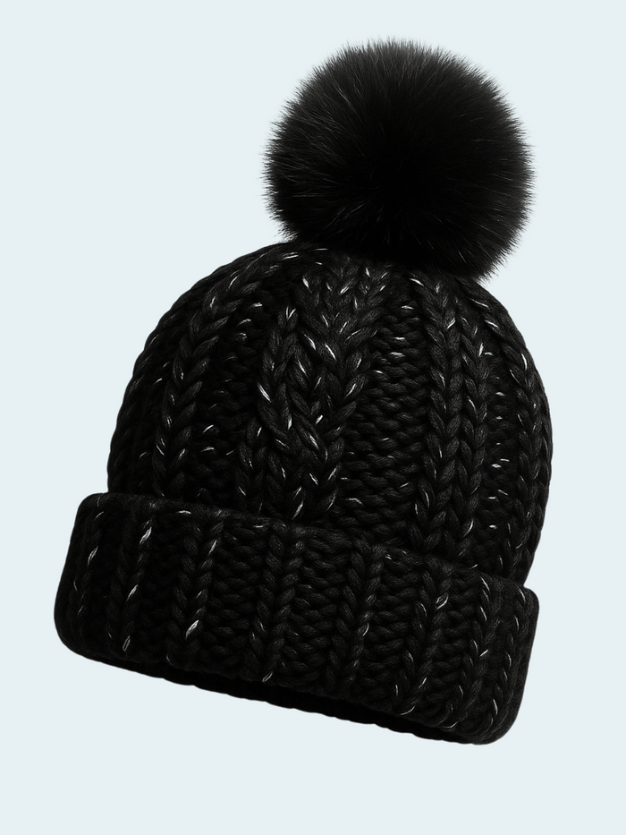 Black knit beanie with a black pom-pom on a light gray background