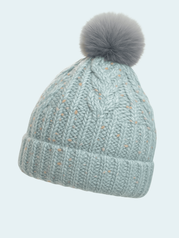 Knitted beanie with a gray pom-pom on a light blue background