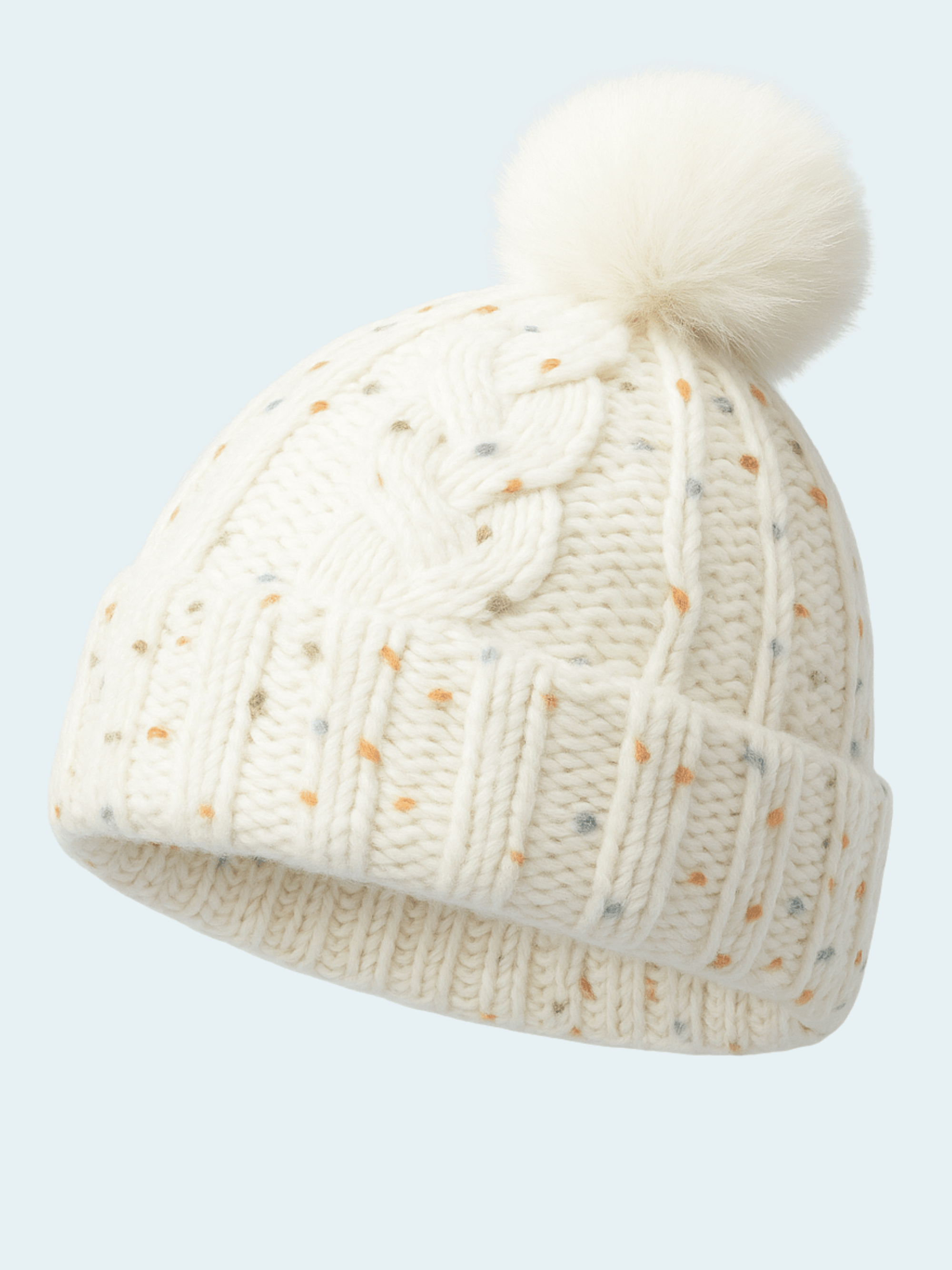 Knitted beanie with a pom-pom on a light gray background