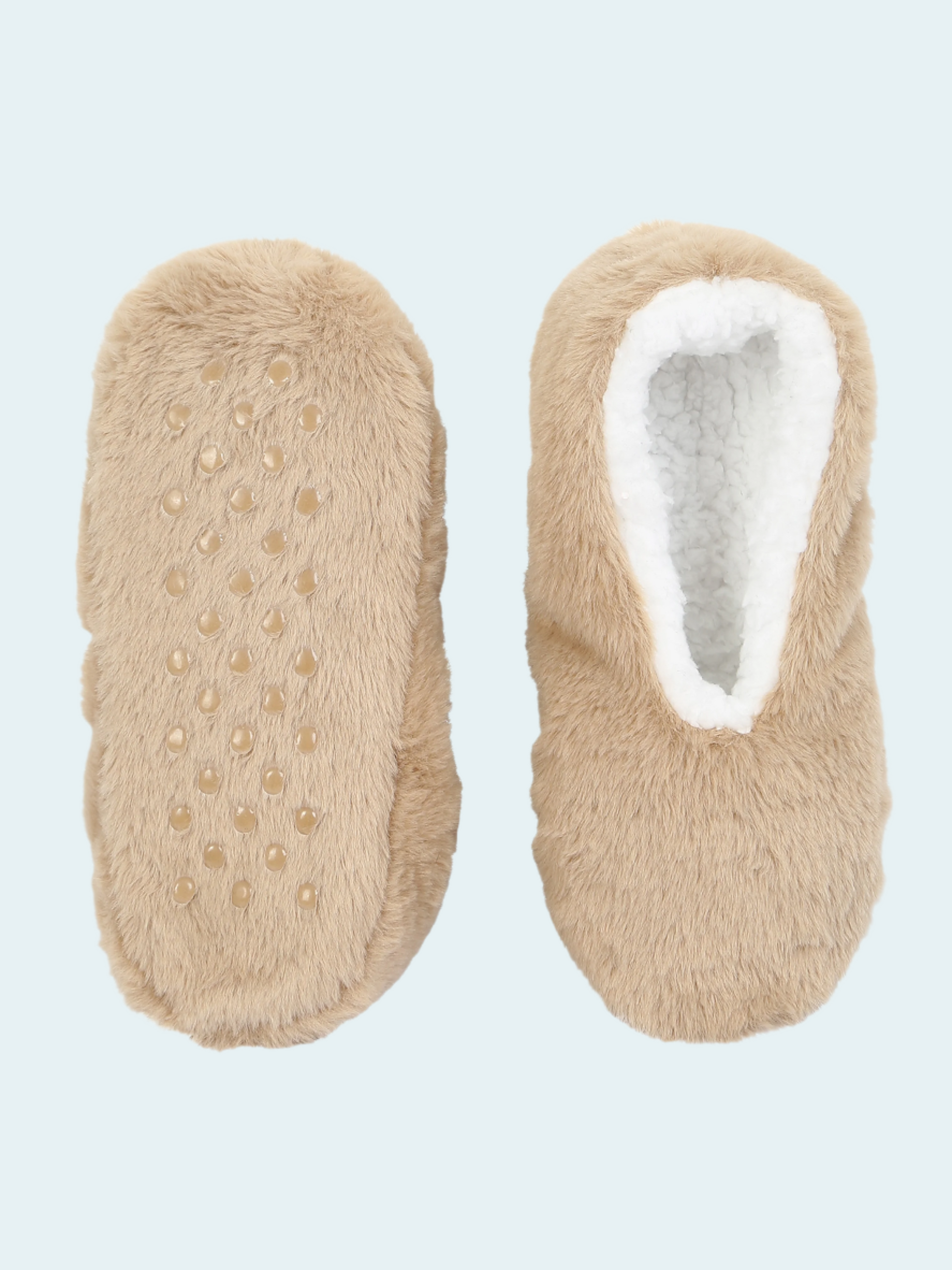 Pair of beige slippers socks with textured sole on a light blue background